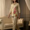 Beige Floral Embroidered Cotton Linen Co-ord Set 2-Piece Ethnic Wear - Front view of a woman wearing a beige two-piece set featuring a tailored button-down shirt with vibrant pink and red floral embroidery and matching straight-cut trousers.