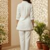 Back view of a woman modeling a breathable white shirt pant co-ord set, showcasing the relaxed drape of the tunic and straight-leg trousers.