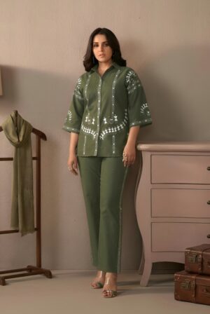 olive green cotton embroidered co-ord set for women - Full-length front view of a girl wearing a set featuring intricate floral embroidery on the shirt and a relaxed fit.