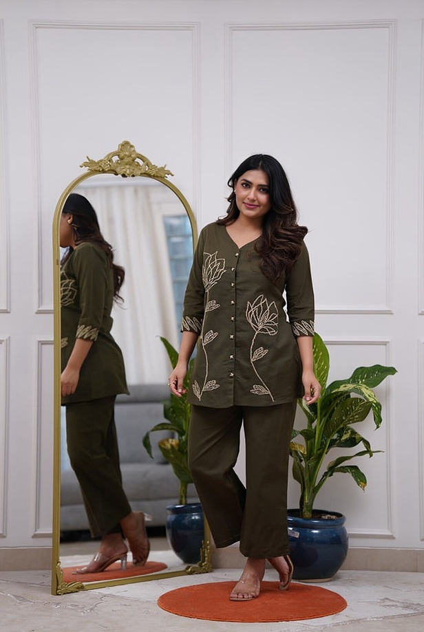 Olive Leaf Outline Embroidered Button-Down Set - a woman wearing the Olive Leaf Outline Outfit, showing the full V-neck tunic and matching trousers.