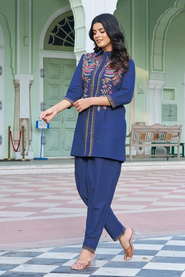 Royal Blue Floral Embroidered Flex-Cotton Co-ord Set - Right side view of a girl with focusing on the high-waist tapered trousers and half-elasticated waistband fit.