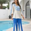 aegean-blue-mosaic-2-piece-palazzo-styled Woman wearing the Aegean Blue mosaic embroidered 2-piece palazzo set, styled with elegant accessories for a complete look.