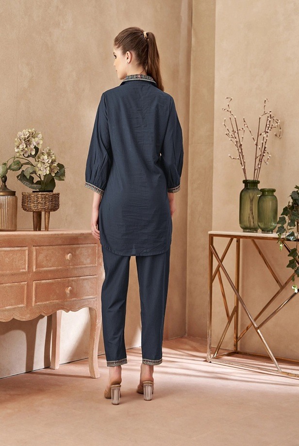 Back view of the women's charcoal blue co-ord set, highlighting the relaxed fit of the long shirt and tailored trousers.