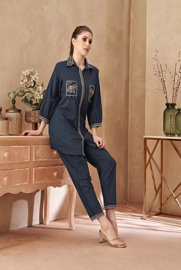 This Elephant Embroidered Outfit Set-Left profile view showing the side drape and geometric embroidered cuff and hem details.