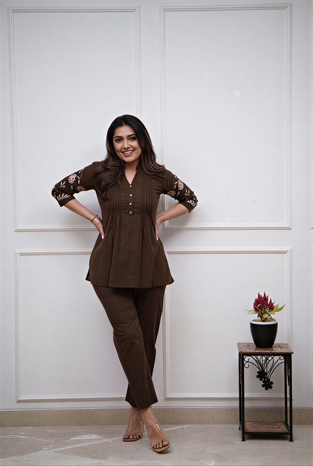 espresso-pin-tuck-mandarin-tunic-coord-styled A lifestyle shot of a woman styling the espresso brown pin-tuck tunic co-ord set as a chic 2-piece Indo-western outfit for a summer event.