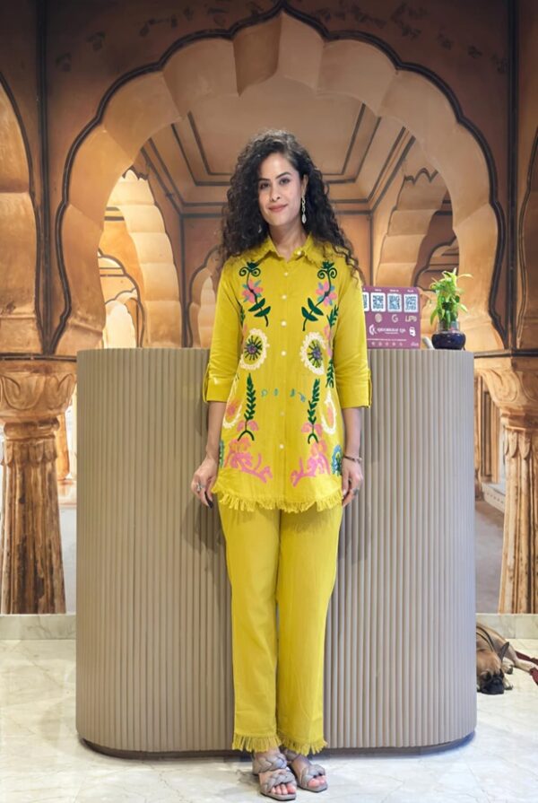 Mustard Yellow Embroidered 2-Piece Co-Ord Set for Women - A full-length lifestyle shot of a woman modeling the outfit, featuring a frayed collar button-down and matching trousers.