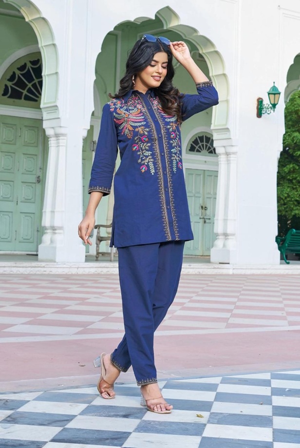 Left-side view of a woman wearing the navy floral Atelier embroidered 2-piece co-ord set, fully styled with accessories.