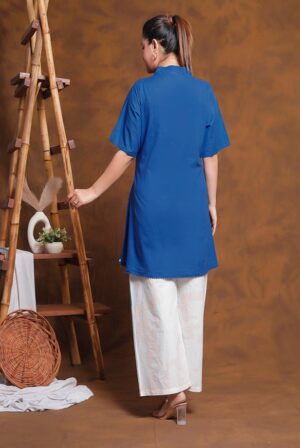 Back view of the royal blue 2-piece tunic and printed pant co-ord set, showing the drape of the top and trouser fit.