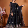 A woman wearing a floor-length black Anarkali gown with pink floral embroidery and a sheer dupatta.
