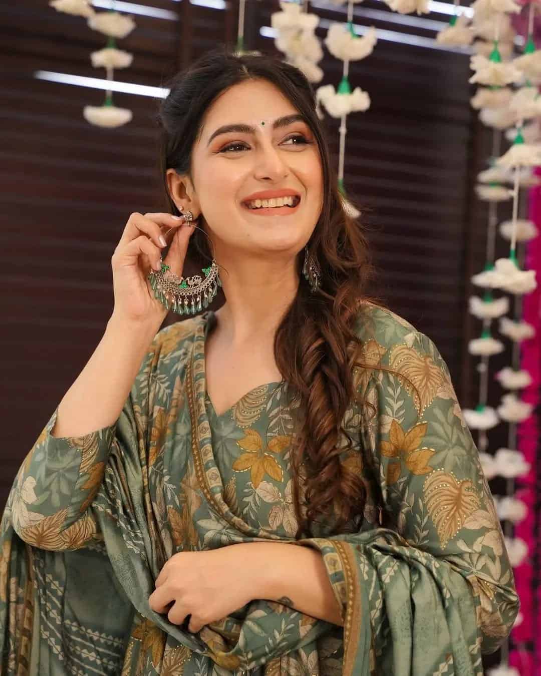 Macro shot of mustard and ivory floral patterns on an olive green fabric base with high-definition botanical motifs.