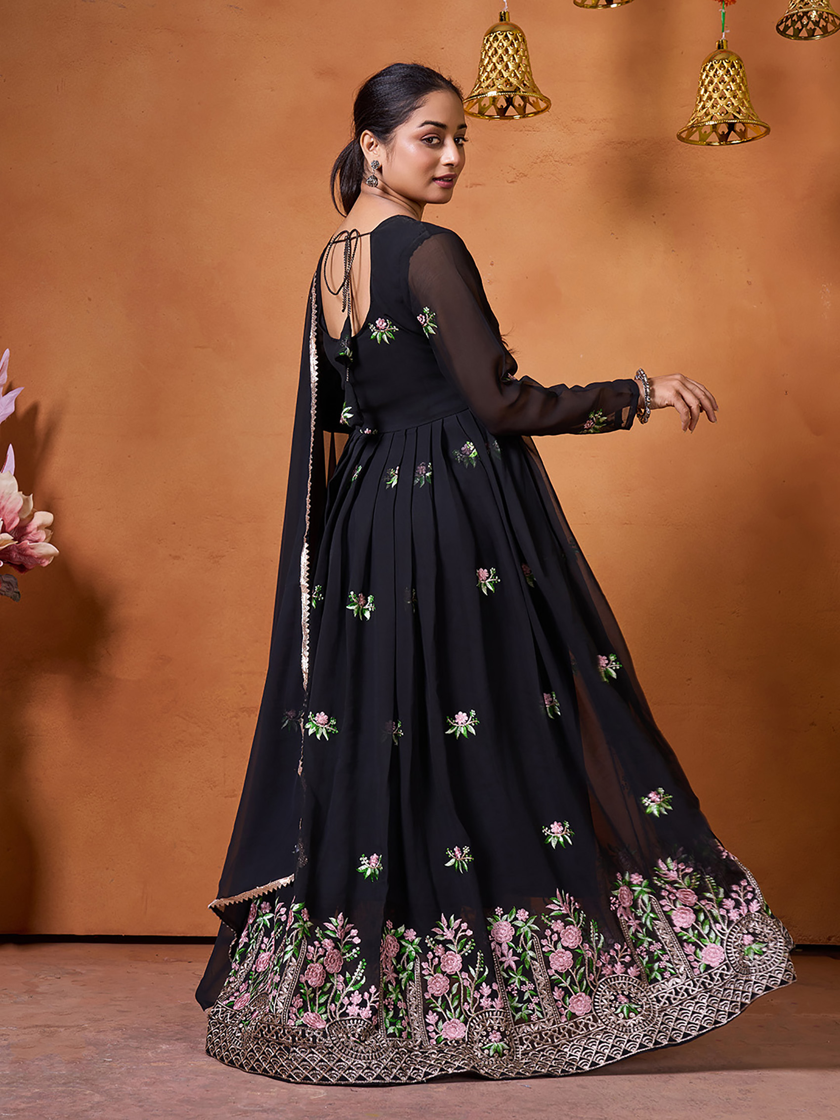 Rear view of a black georgette gown showing a deep neck design and flowing sheer sleeves.
