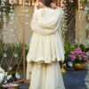 Rear view of an ivory organza peplum kurta showing a deep V-back design and a sweeping flared hem.