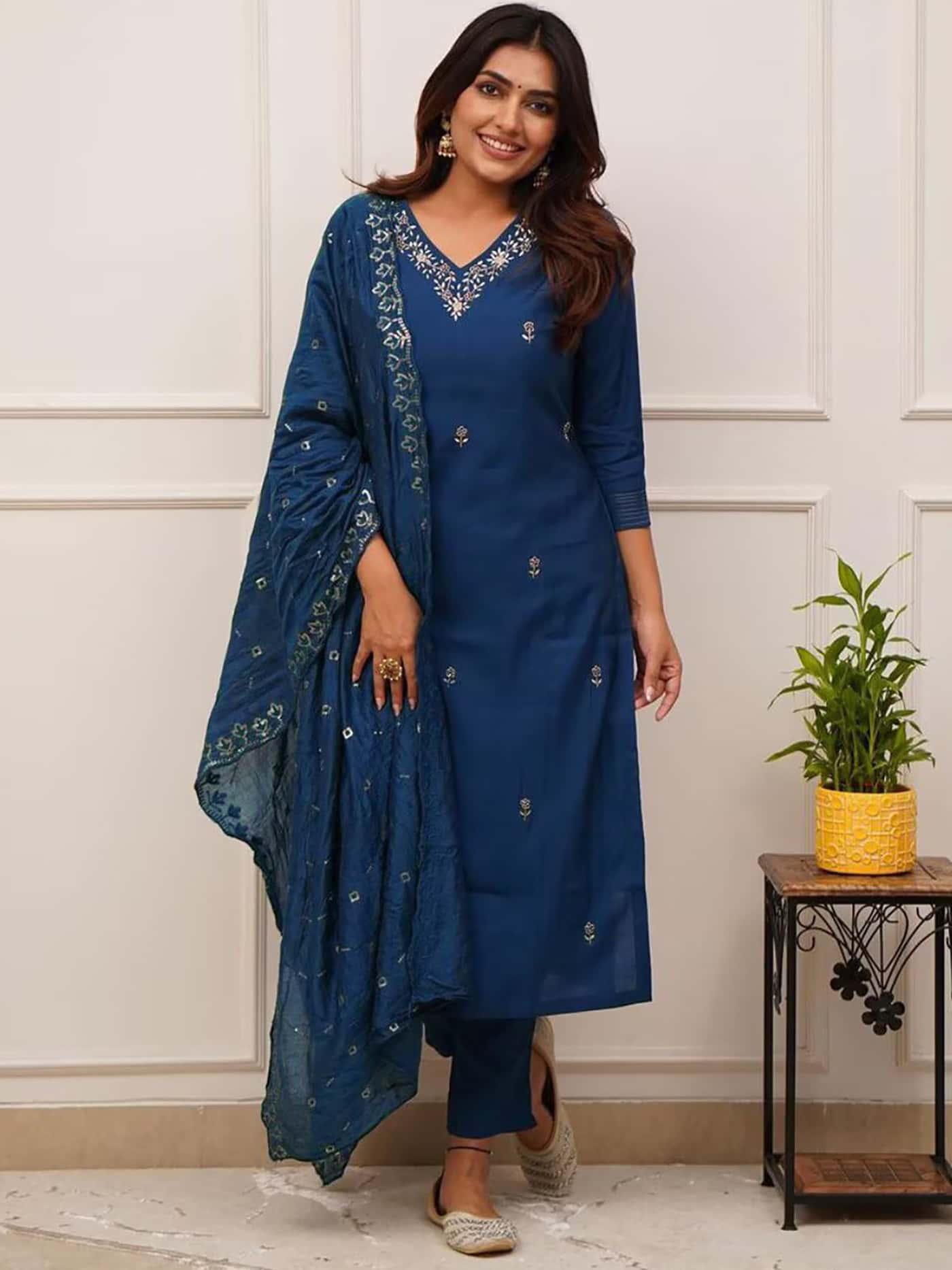 A model styled with traditional jhumkas and pearl-work juttis wearing the Sapphire Blue Designer Kurta Set.