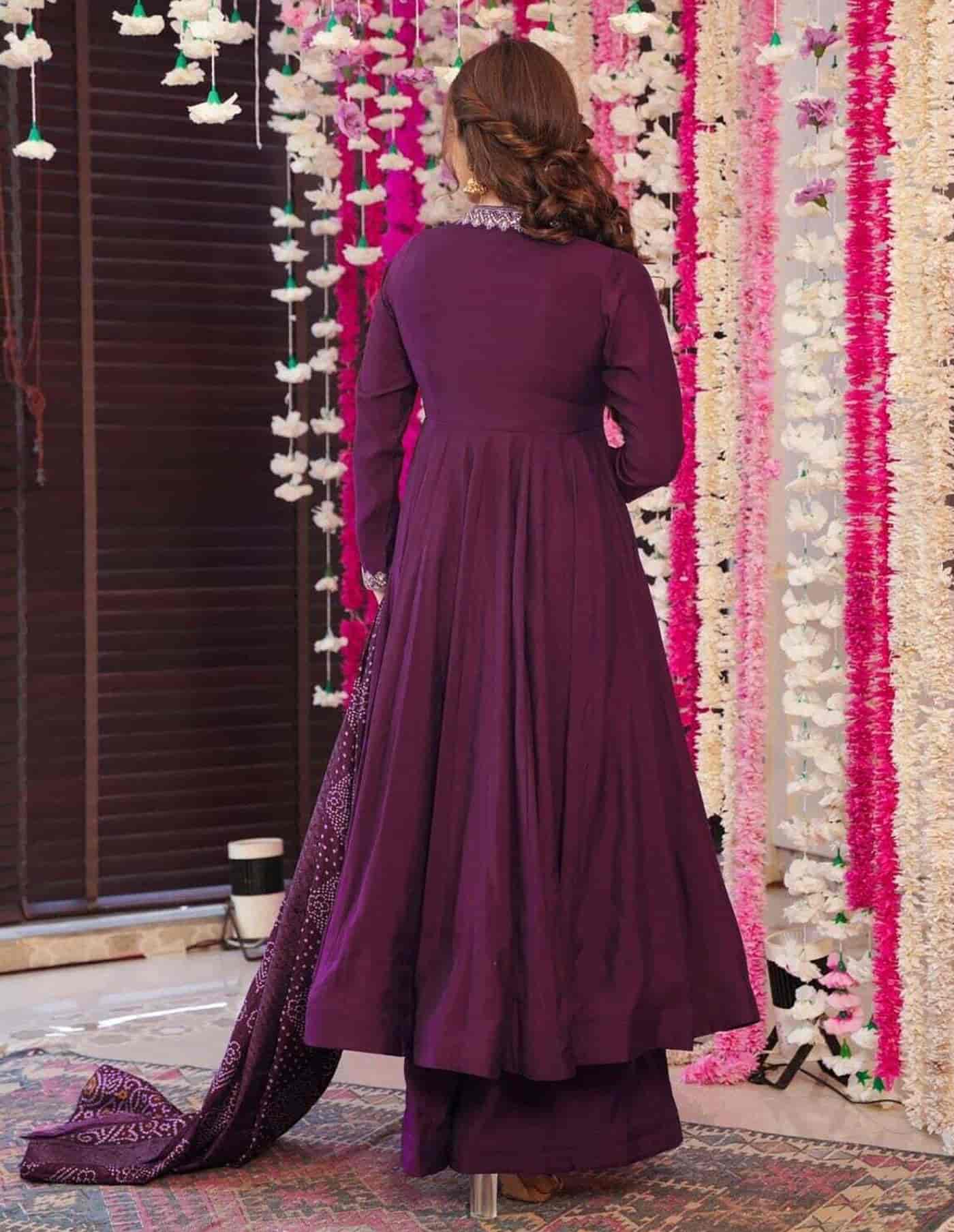 Rear view of a deep wine silk-blend Anarkali showing a clean back design and the voluminous floor-length flare.