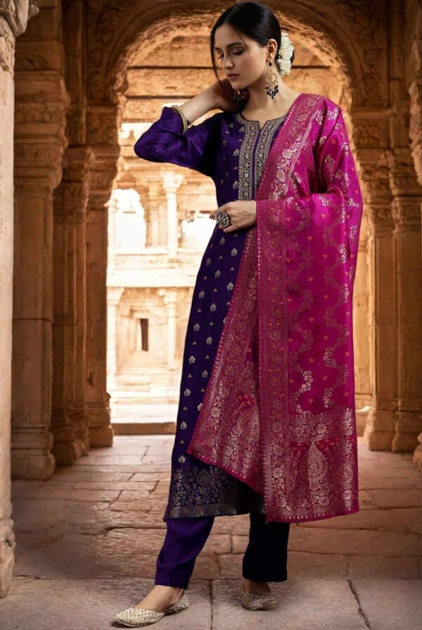 A woman wearing a premium amethyst purple silk kurta with gold zari neck detailing and a contrast magenta dupatta.