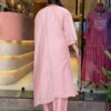 Rear view of a blush pink silk-blend kaftan showing a clean finish and the fluid, airy drape of the fabric.