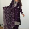 A woman wearing a deep plum purple straight-fit kurta with silver zari embroidery and a matching dupatta.
