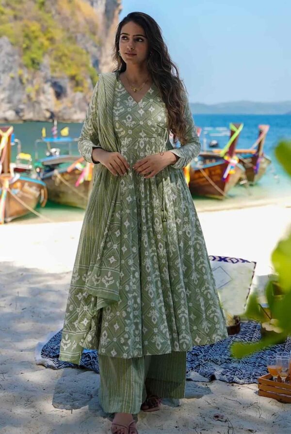 A woman wearing a sage green block-printed Angrakha kurta with a flared hem and matching palazzo pants.