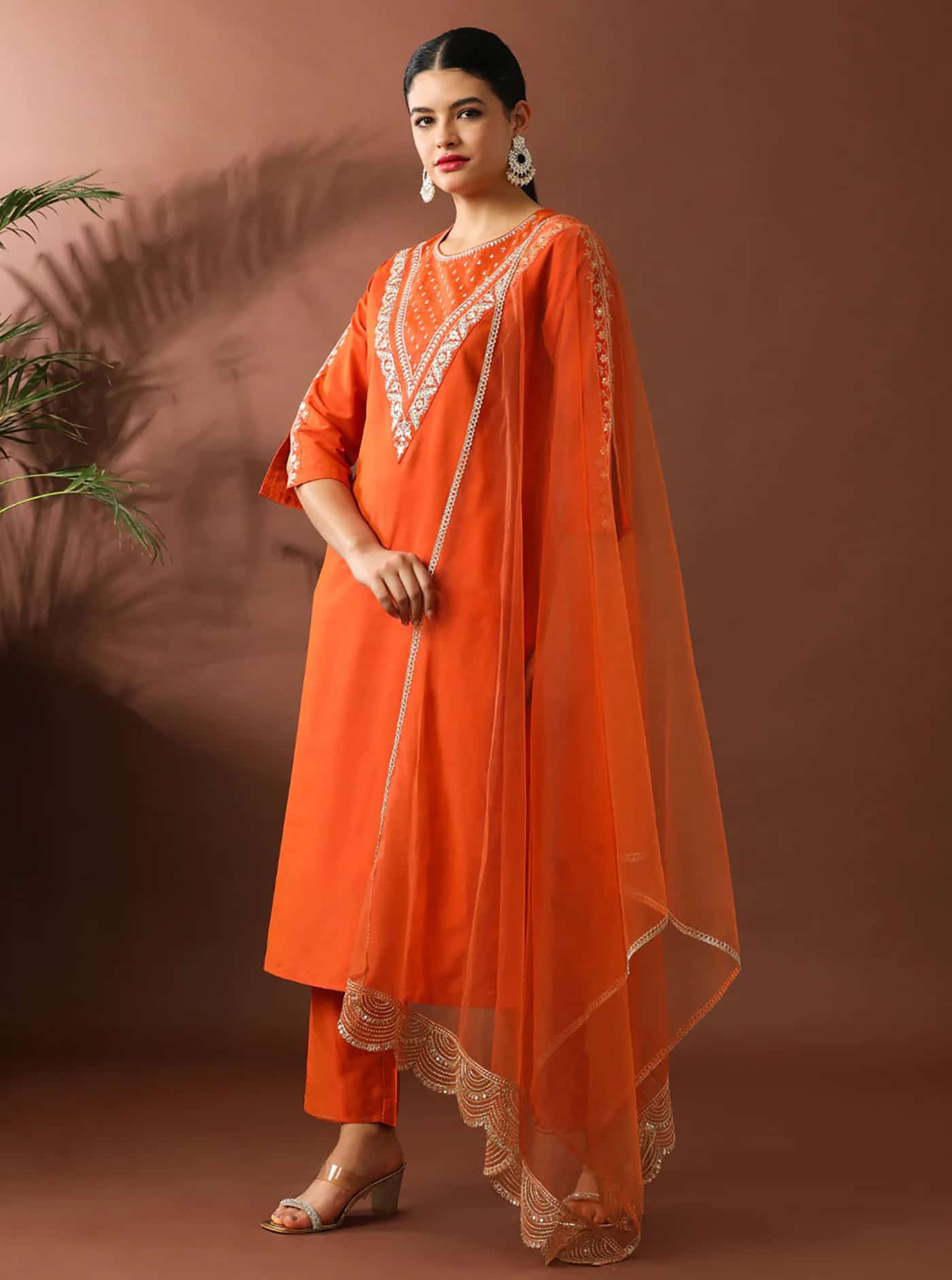 Side shot of a blue silk suit set highlighting the side slits and the textured drape of the matching dupatta.