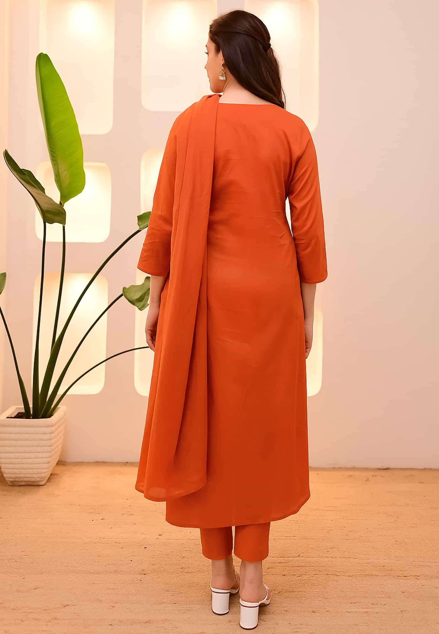 Rear view of a saffron orange silk kurta showing a clean-cut A-line silhouette and premium fabric texture.