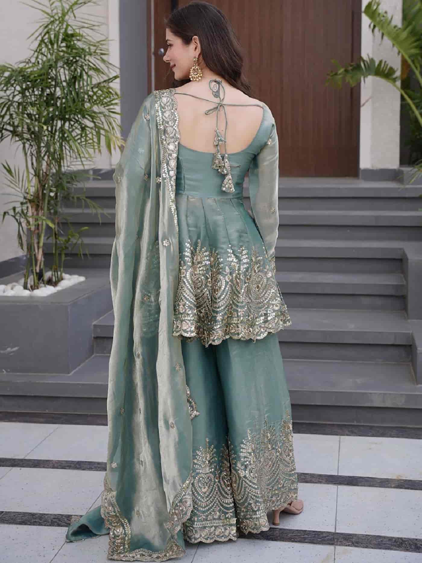 Rear view of a seafoam green silk kurta showing a structured fit and the smooth, premium metallic sheen of the silk.